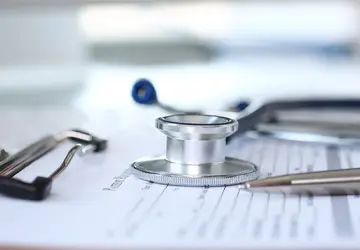 Stethoscope head on medical form