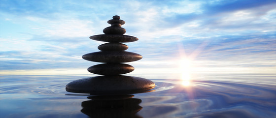 Pile of rocks in a lake at sunrise